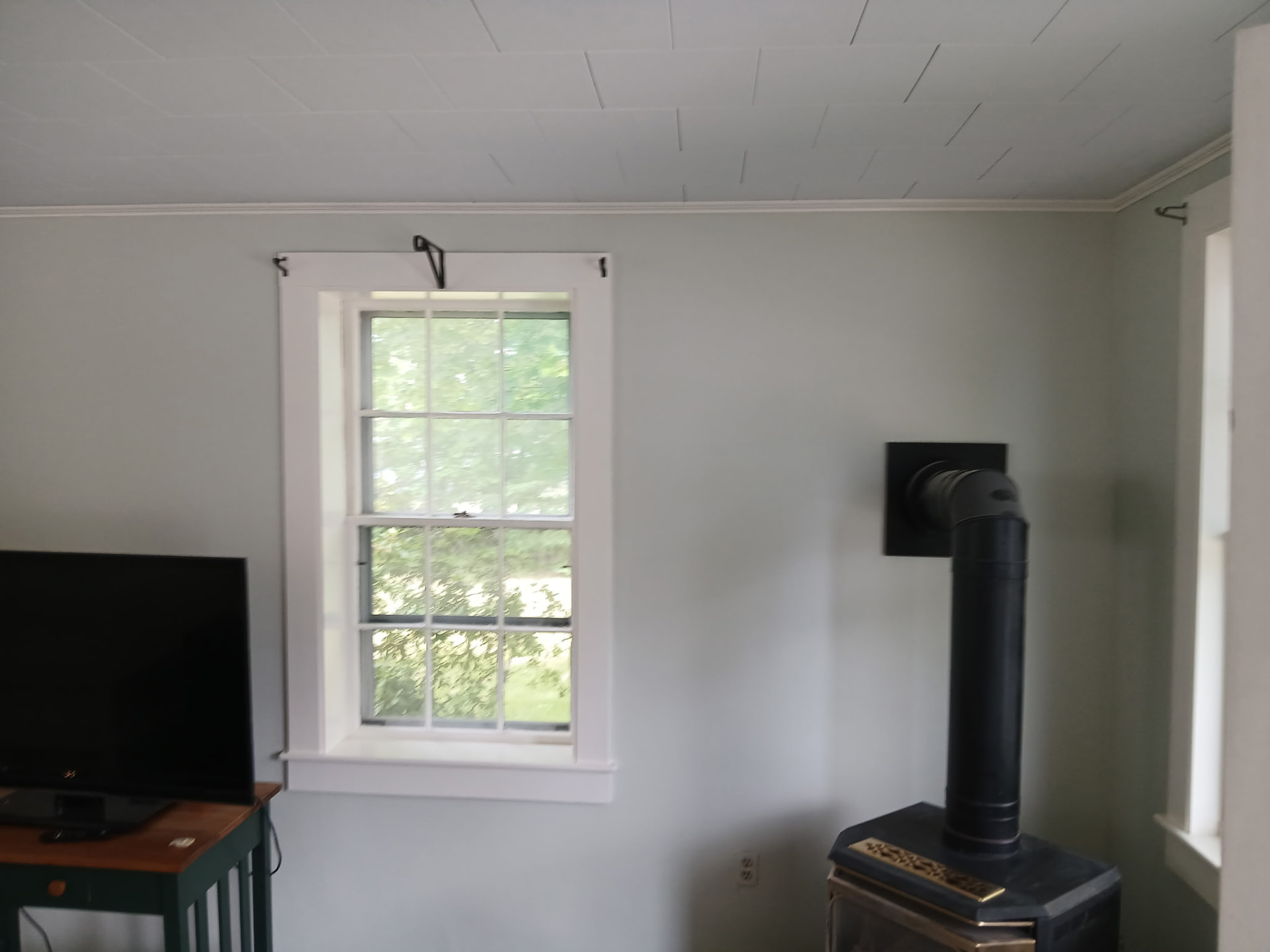 Living room with light gray walls and freshly painted white window trim