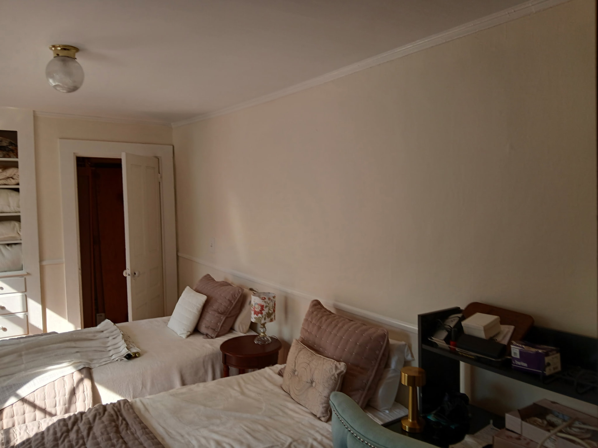 Guest bedroom repainted in soft neutral with crisp white trim